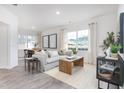 Bright living room boasts hardwood floors, a comfortable sofa, and abundant natural light at 228 Moyer Dr, Graham, NC 27253