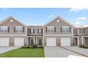 Exterior showcasing new townhomes, attached garages, covered entryways, and well-kept landscaping at 236 Moyer Dr, Graham, NC 27253