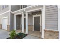 Covered front porch with support columns, neutral siding, and a well-manicured landscape at 236 Moyer Dr, Graham, NC 27253