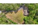 An aerial view of a home with a large yard, a long driveway, and surrounded by trees at 237 Jason Way, Youngsville, NC 27596