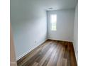 Cozy bedroom with wood floors and a window offering natural light at 2403 Whitewing Ln, Wendell, NC 27591