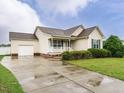 Quaint one-story home showcasing an attached garage and a freshly sealed driveway at 253 Middle Landing Dr, Smithfield, NC 27577