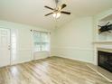 Inviting living room with new flooring, a ceiling fan and a cozy fireplace at 253 Middle Landing Dr, Smithfield, NC 27577