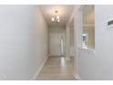 Bright entryway featuring hardwood floors, white trim, and a view into the main living space at 263 Hopewell Branch Ct, Smithfield, NC 27577
