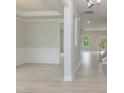 Spacious room with hardwood floors, white trim, and a view into an adjacent dining area at 263 Hopewell Branch Ct, Smithfield, NC 27577