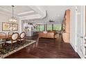 Open-concept living space with hardwood floors connecting a dining area, kitchen, and living room at 2633 Beckwith Rd, Apex, NC 27523