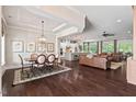A harmonious blend of kitchen, dining, and living areas featuring hardwood floors and natural light at 2633 Beckwith Rd, Apex, NC 27523