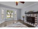 Cozy living room with a bay window, decorative fireplace, and hardwood floors at 2705 Kempsford Pl, Raleigh, NC 27604