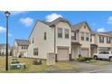 Townhome showcasing attached garage and neat front lawn on a sunny day at 303 Leighann Ridge Ln, Rolesville, NC 27571
