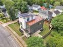 Aerial view of modern home featuring a rooftop patio, solar panels, and a carport at 304 S Tarboro St, Raleigh, NC 27610