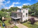 Modern two-story home with rooftop patio and carport, set on a beautifully landscaped lot at 304 S Tarboro St, Raleigh, NC 27610