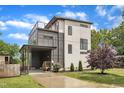 Contemporary two-story home with a unique rooftop patio, gray siding, and a convenient carport at 304 S Tarboro St, Raleigh, NC 27610