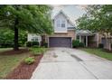 Home exterior featuring a two-car garage, landscaping and stone details at 306 Plank Bridge Way, Morrisville, NC 27560