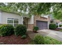 Inviting home exterior with stone accents and a well-manicured lawn at 306 Plank Bridge Way, Morrisville, NC 27560