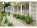 Charming front porch with white rocking chairs and manicured landscaping at 318 Tillamook Dr, Wake Forest, NC 27587