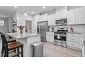 Bright kitchen with stainless steel appliances, granite countertops, and a central island with seating at 320 Everly Mist Way, Wake Forest, NC 27587