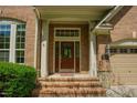 Close-up of brick home's front entrance, showcasing a solid wood door and classic design at 3911 Morvan Way, Raleigh, NC 27612