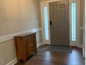 Welcoming entryway with wood floors, accent cabinet, and ample natural light at 4001 Newby Rd, Rocky Mount, NC 27804
