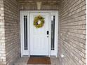 Inviting front entrance featuring a white door, sidelights, and brick surround at 4001 Newby Rd, Rocky Mount, NC 27804