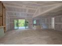 Spacious living room with sliding glass doors offering view of lush green landscape at 4248 Jacks Creek Trl, Burlington, NC 27215