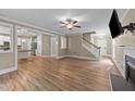 Open-concept living area with hardwood floors, fireplace, and staircase, great for entertaining and Gathering gatherings at 436 Edgepine Dr, Holly Springs, NC 27540