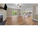 Spacious living room with hardwood floors, fireplace, and large window offering plenty of natural light at 436 Edgepine Dr, Holly Springs, NC 27540