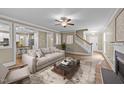 Inviting living room with a neutral color palette, hardwood floors, a fireplace, and a ceiling fan at 436 Edgepine Dr, Holly Springs, NC 27540