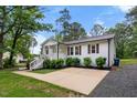 Well-maintained home featuring a bright front porch and a neat driveway surrounded by green grass and plantings at 5020 Mimosa Dr, Durham, NC 27713
