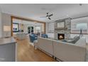 Open-concept living room with a stone fireplace, built-in shelving, and hardwood floors at 511 Hamilton Cottage Way, Raleigh, NC 27605