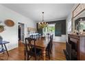 Elegant dining room featuring a large wooden table, a decorative chandelier, and vintage accents at 5308 Stableview Ct, Holly Springs, NC 27540