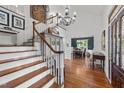 Spacious foyer with hardwood floors, a grand staircase, and views into the dining area, creating an inviting entrance at 5308 Stableview Ct, Holly Springs, NC 27540