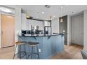 Modern kitchen features a breakfast bar, pendant lighting, and sleek appliances for a contemporary feel at 618 N Boylan Ave # 810, Raleigh, NC 27603