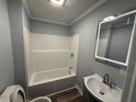 Clean bathroom offers a tub/shower combination, a modern sink vanity, and an updated LED mirror at 65 Prospect Church Rd, Erwin, NC 28339