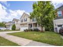 Charming two-story home with manicured lawn, driveway and mature trees at 702 Crosstie St, Knightdale, NC 27545