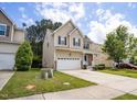 Inviting two-story home with front yard, long driveway, and attached two car garage at 702 Crosstie St, Knightdale, NC 27545