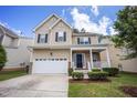 Inviting two-story home with front yard, long driveway, and attached two car garage at 702 Crosstie St, Knightdale, NC 27545