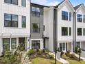Modern townhouse showcases mixed siding materials, neat landscaping, and welcoming walkways at 710 W North St # 103, Raleigh, NC 27603