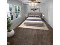 Staged bedroom with neutral tones, carpet flooring, and natural light streaming through the large windows at 720 Rawls Dr, Raleigh, NC 27610