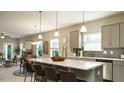 Open concept kitchen with a large island, bar seating, and stainless steel appliances provides ample space at 75 E American Marigold Dr # 37, Benson, NC 27504