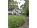 Expansive backyard with a well-manicured lawn, patio, and deck, perfect for outdoor entertaining and relaxation at 7517 Chippenham Ct, Raleigh, NC 27613
