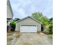 Spacious detached two-car garage featuring an extra-wide driveway, and manicured landscape at 7621 Troy Stone Dr, Fuquay Varina, NC 27526