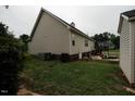 Exterior view featuring a tidy backyard, with an outbuilding, a swing set, and mature trees at 780 Pondview Ct, Rocky Mount, NC 27804