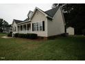 Well-maintained side of the home featuring classic siding, trimmed bushes, and tidy lawn at 780 Pondview Ct, Rocky Mount, NC 27804