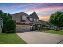 Charming two-story home boasting a manicured lawn, stone accents, and attached two-car garage at 82 Idlewood Ln, Clayton, NC 27527