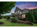 Charming two-story home with beautiful landscaping, stone accents, and lush greenery at 82 Idlewood Ln, Clayton, NC 27527