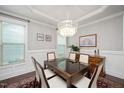 Formal dining room with wainscoting, chandelier, and plenty of natural light at 821 Laurel Garden Way, Cary, NC 27513