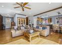 Comfortable living room with hardwood floors, exposed wood beams, and sofas, creating a relaxing atmosphere at 8437 Charlie Stovall Rd, Oxford, NC 27565
