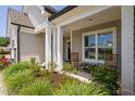 Comfortable front porch with rocking chairs and beautiful landscaping at 901 Del Webb Manor Ave, Wake Forest, NC 27587