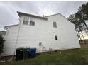 A white siding wall is seen on the side of this home with necessary utilities neatly arranged at 10 Gwendolyn Cir, Durham, NC 27703