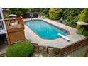 An in-ground pool is surrounded by a patio, landscaping, a diving board, and a basketball hoop at 1004 Taywood Way, Apex, NC 27502